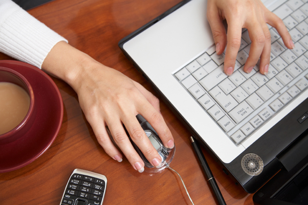 Female hands typing on a laptop